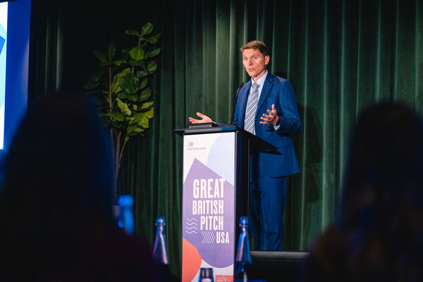 A speaker addressing guests from the Great British Pitch USA lectern